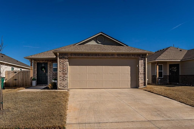 single story home with a garage and a front lawn