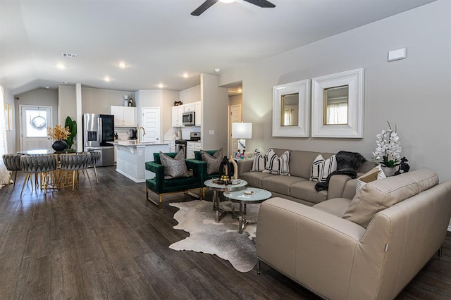 living room featuring ceiling fan, lofted ceiling, and dark hardwood / wood-style flooring