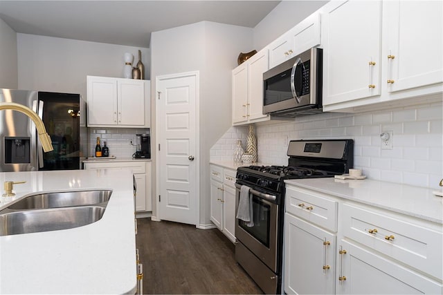 kitchen featuring sink, dark hardwood / wood-style floors, white cabinets, and appliances with stainless steel finishes