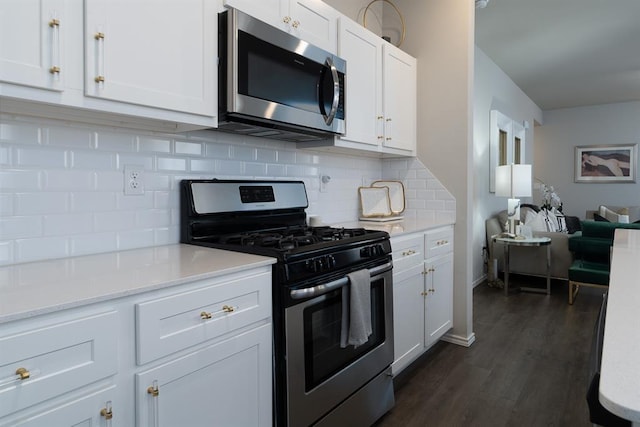 kitchen featuring backsplash, appliances with stainless steel finishes, dark hardwood / wood-style floors, and white cabinets