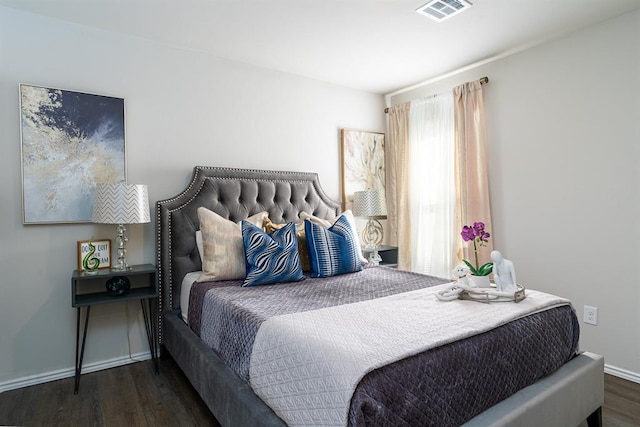 bedroom with dark hardwood / wood-style floors