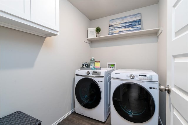 washroom with cabinets, dark wood-type flooring, and washer and dryer