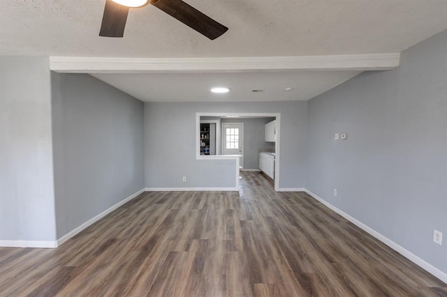 unfurnished living room with ceiling fan and dark hardwood / wood-style flooring