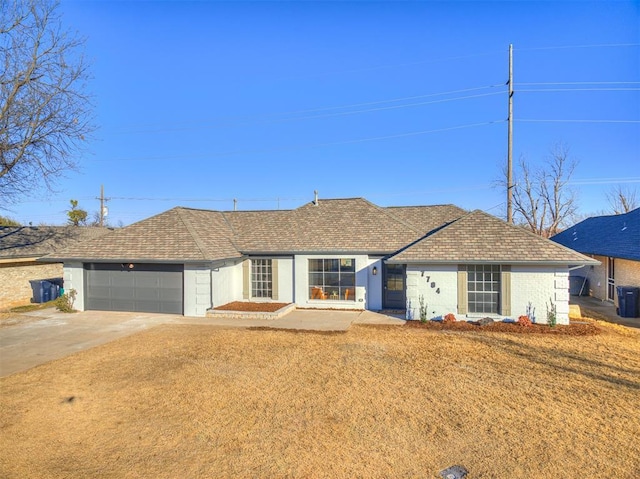 single story home with a garage and a front lawn