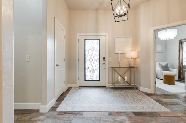 entryway with an inviting chandelier and dark hardwood / wood-style floors