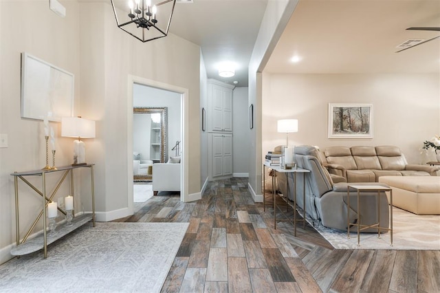 interior space with an inviting chandelier and dark hardwood / wood-style flooring