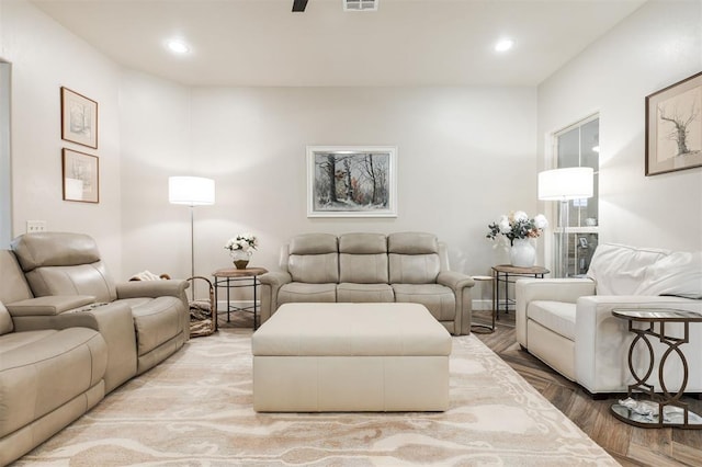 living room with ceiling fan and light wood-type flooring