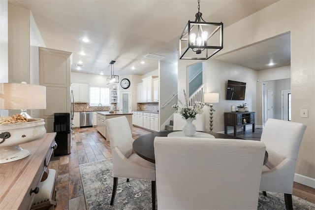 dining room featuring sink and an inviting chandelier