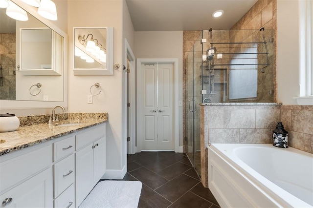 bathroom with tile patterned flooring, vanity, and plus walk in shower