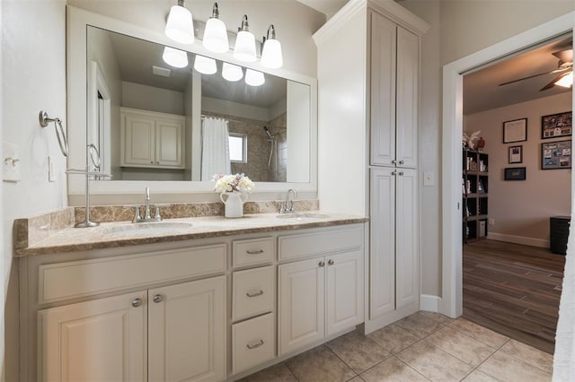 bathroom with a shower with curtain, ceiling fan, tile patterned floors, and vanity