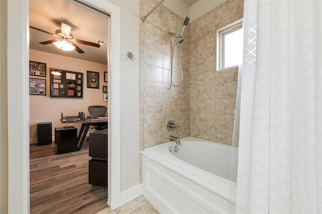 bathroom featuring ceiling fan, wood-type flooring, and shower / tub combo