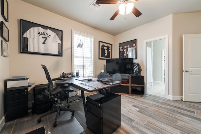 home office featuring ceiling fan and light hardwood / wood-style floors