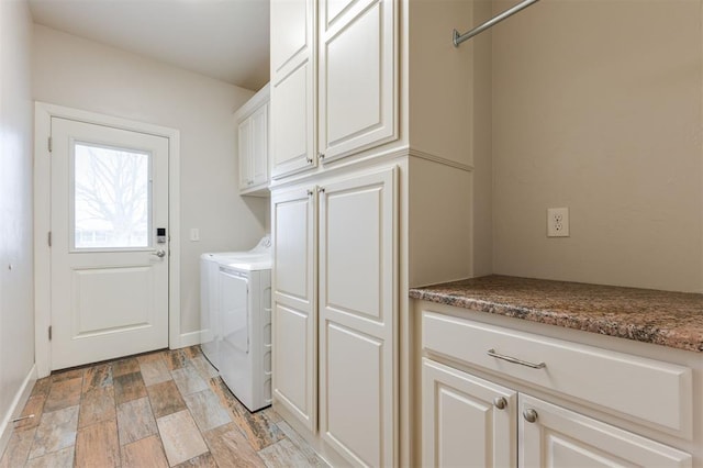 washroom with cabinets and separate washer and dryer