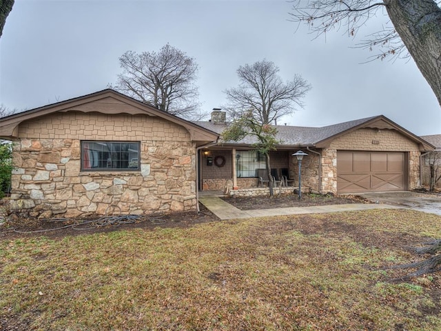 ranch-style house featuring a garage and a front yard