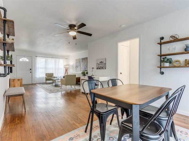 dining room with ceiling fan and light hardwood / wood-style flooring