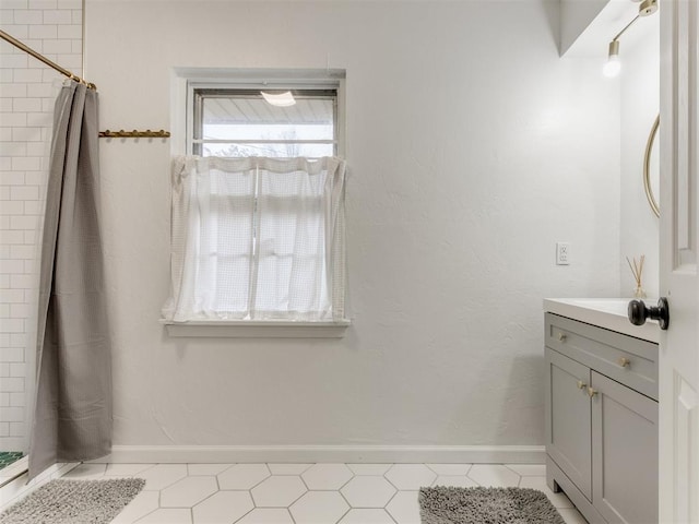 bathroom with vanity, curtained shower, and tile patterned floors