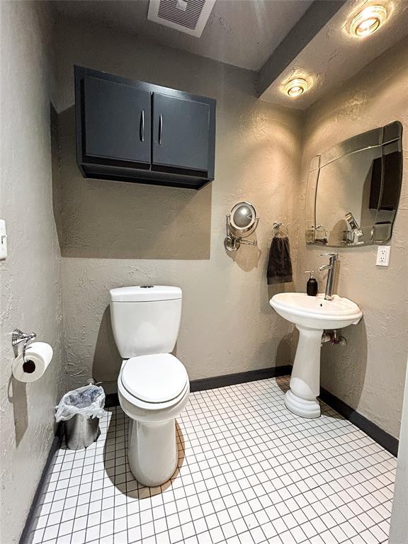 bathroom with tile patterned floors and toilet