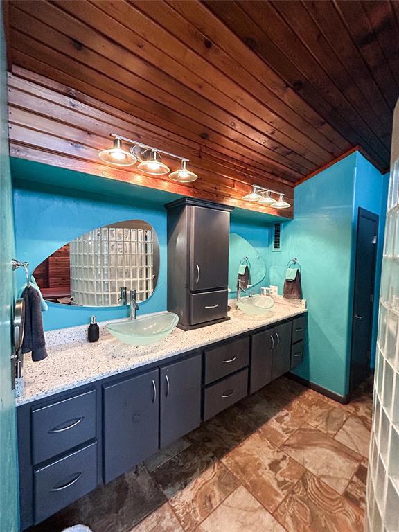 bathroom with vanity, vaulted ceiling, and wooden ceiling