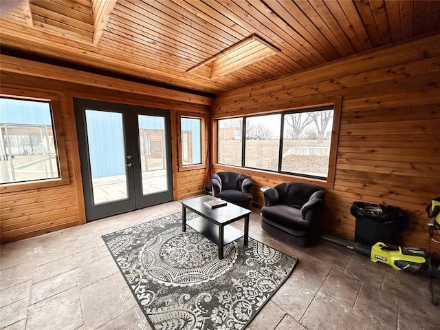 living room with a skylight, wooden walls, wooden ceiling, and french doors