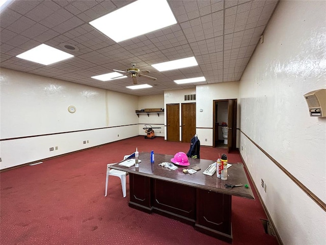 carpeted office with ceiling fan and a paneled ceiling