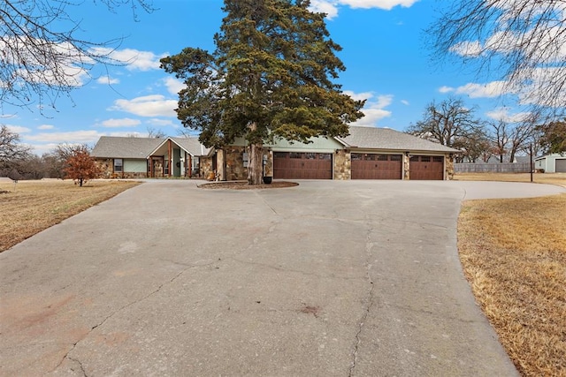 single story home with a garage and a front yard