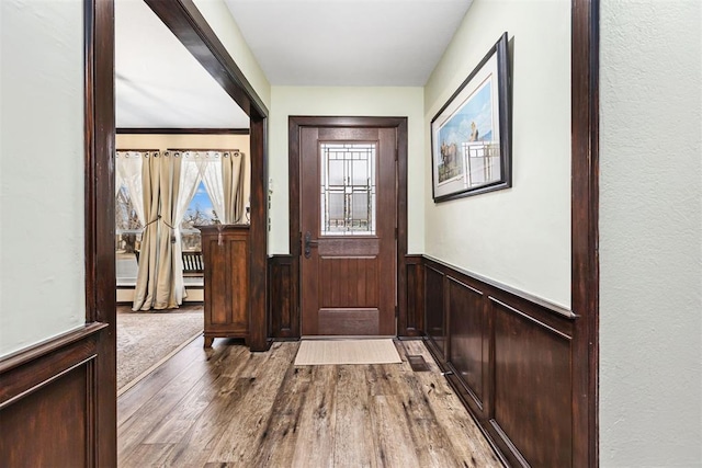 foyer with hardwood / wood-style flooring and baseboard heating