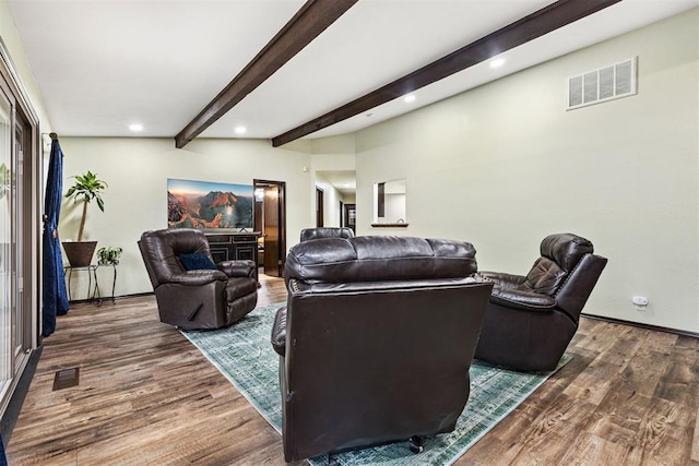 living room featuring beam ceiling and dark wood-type flooring