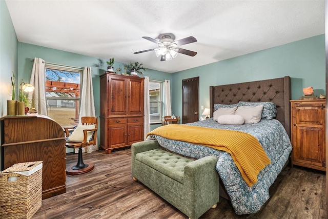 bedroom with dark wood-type flooring and ceiling fan