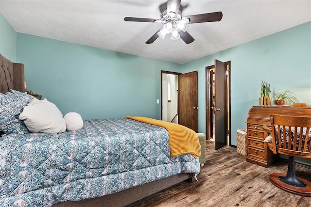 bedroom featuring hardwood / wood-style floors and ceiling fan