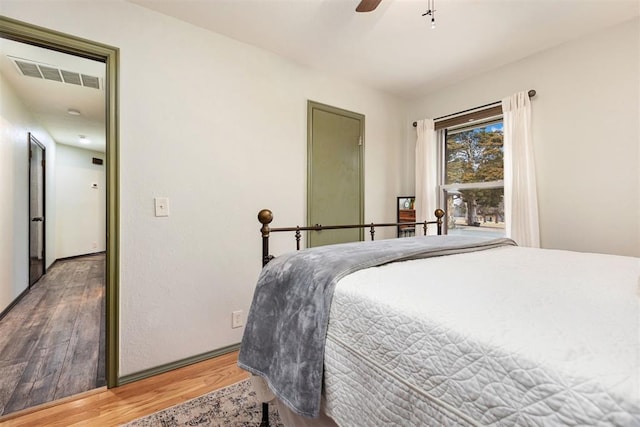 bedroom with hardwood / wood-style flooring and ceiling fan