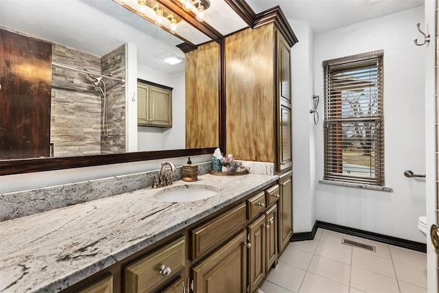 bathroom featuring vanity, tile patterned floors, and toilet