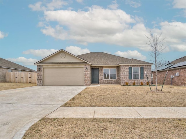 ranch-style home with a garage and a front lawn