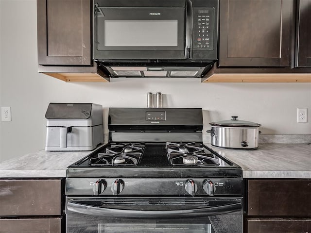 kitchen with dark brown cabinetry, ventilation hood, and black appliances
