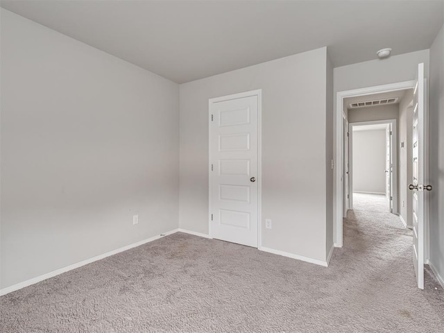 unfurnished bedroom featuring light carpet