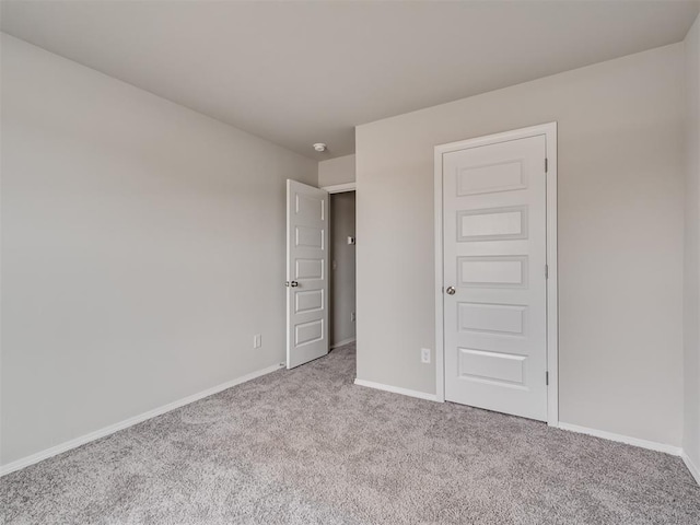 unfurnished bedroom featuring light carpet