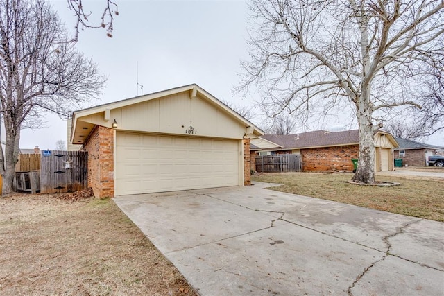 view of side of property with a garage and a lawn