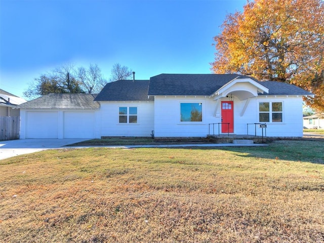 ranch-style home with a garage and a front lawn