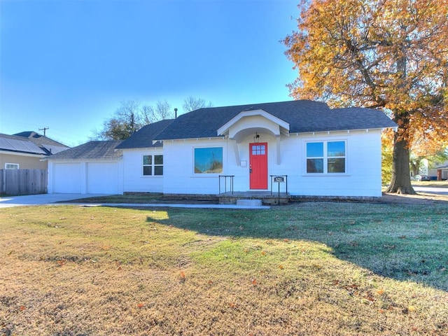 ranch-style home featuring a garage and a front lawn