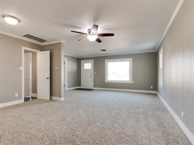 interior space with light carpet, crown molding, and ceiling fan