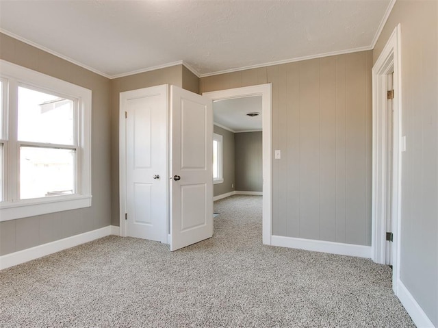 unfurnished bedroom featuring crown molding and light colored carpet