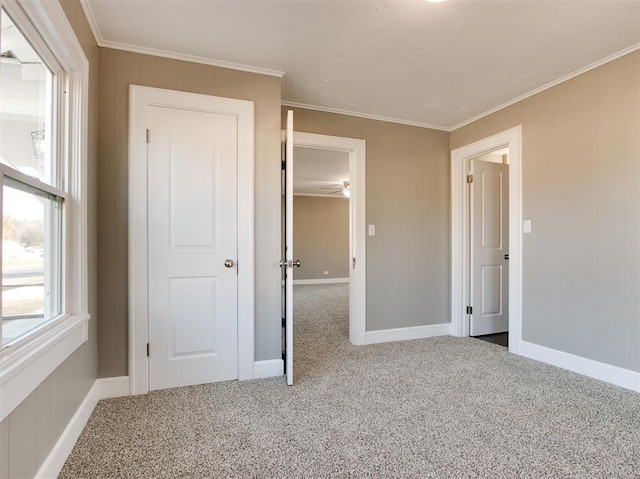 unfurnished bedroom with crown molding and carpet flooring