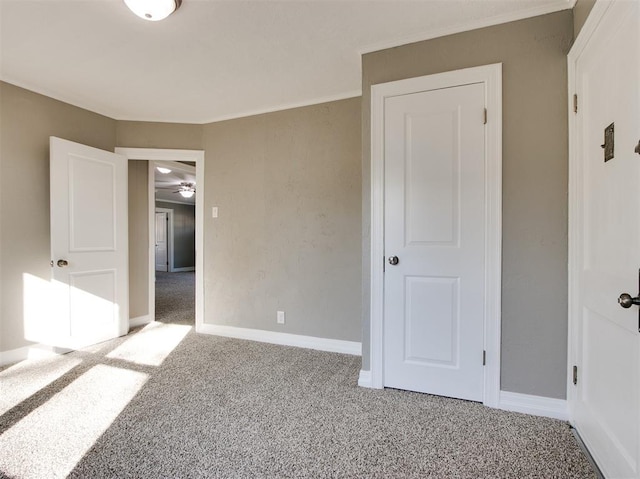 unfurnished bedroom with ornamental molding and carpet