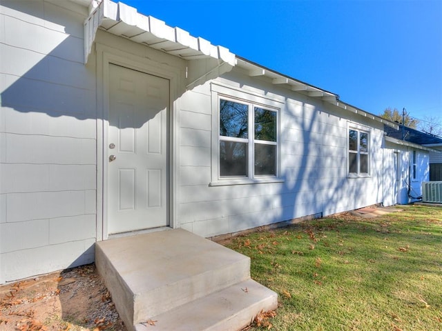 entrance to property with a lawn