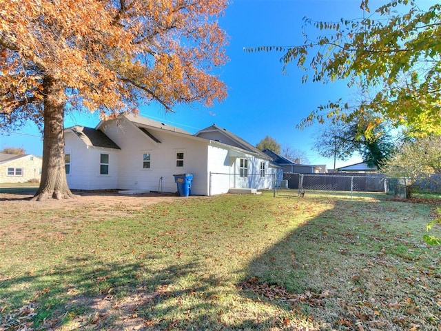 rear view of property with a yard