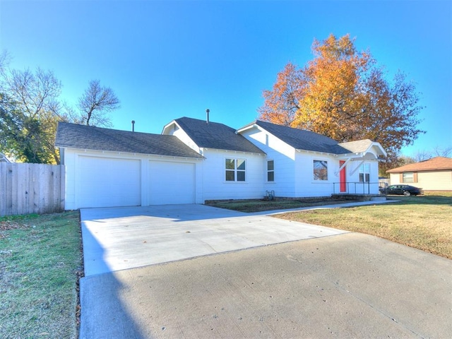 view of front of property featuring a garage and a front lawn