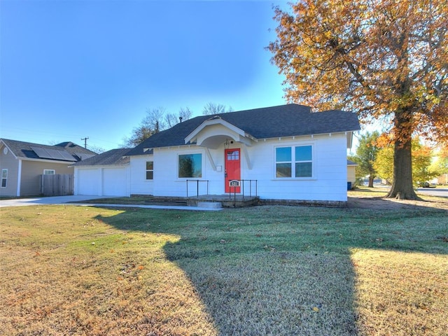 view of front of house with a garage and a front lawn