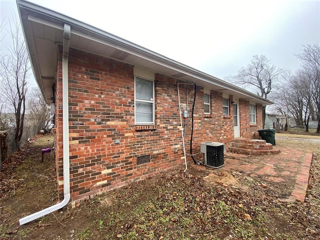 view of side of home featuring central AC unit