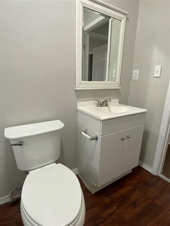 bathroom with vanity, hardwood / wood-style floors, and toilet