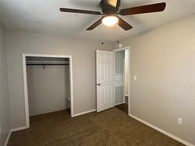 unfurnished bedroom with a closet, ceiling fan, and dark colored carpet