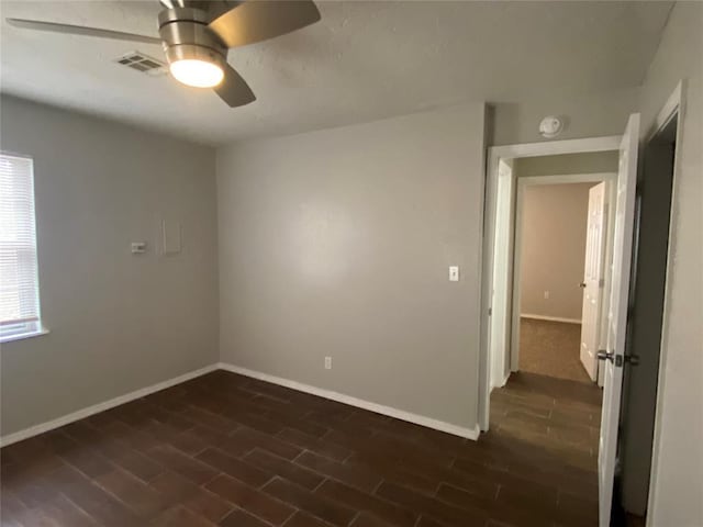 spare room featuring ceiling fan and dark hardwood / wood-style flooring